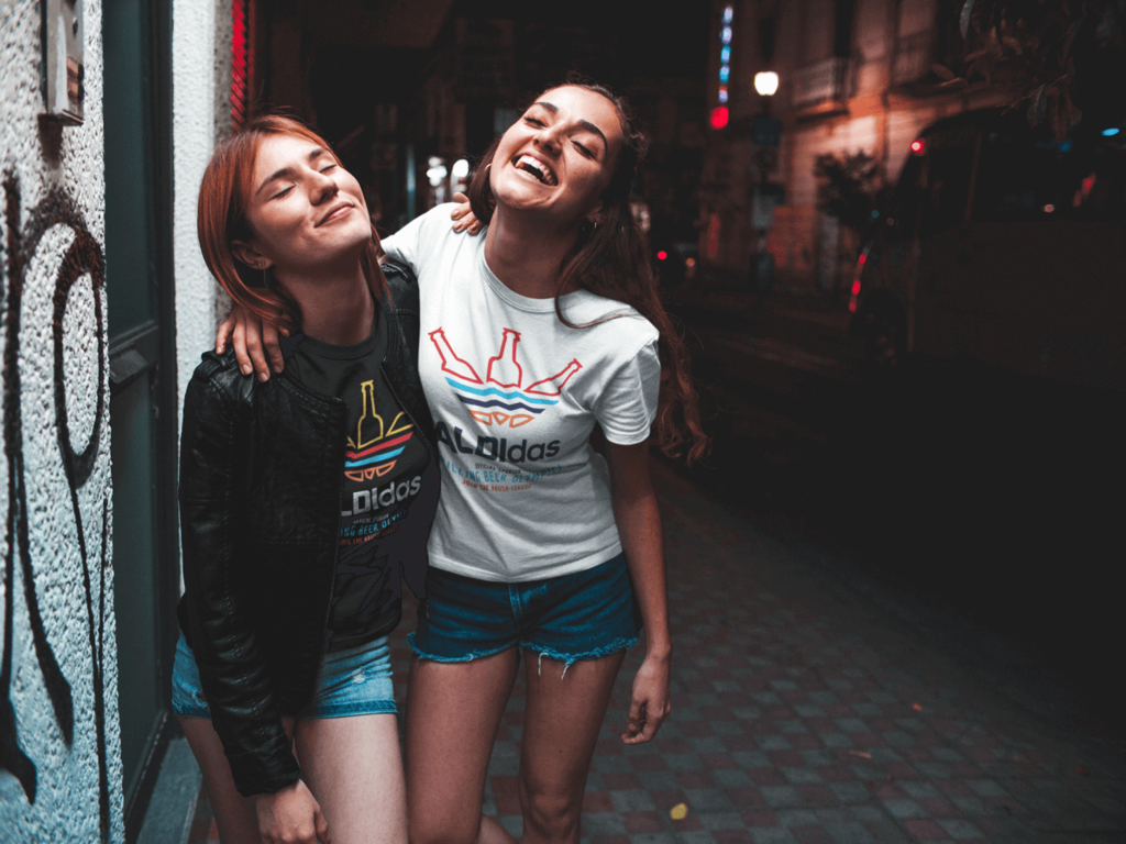 two young woman on street wearing black tshirts with aldidas design by funnydrinking.com.png